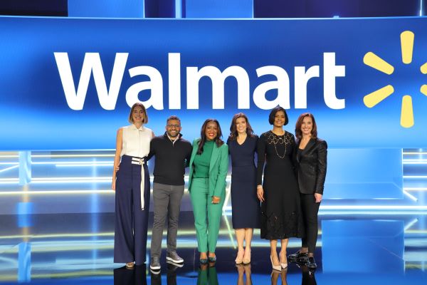 Walmart's keynote speakers are grouped together and smiling for a photo.