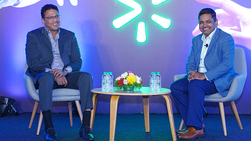 Indian tennis legend Mahesh Bhupathi and Walmart Global Tech SVP & Country Head, Balu Chaturvedula sharing a laugh on stage. 