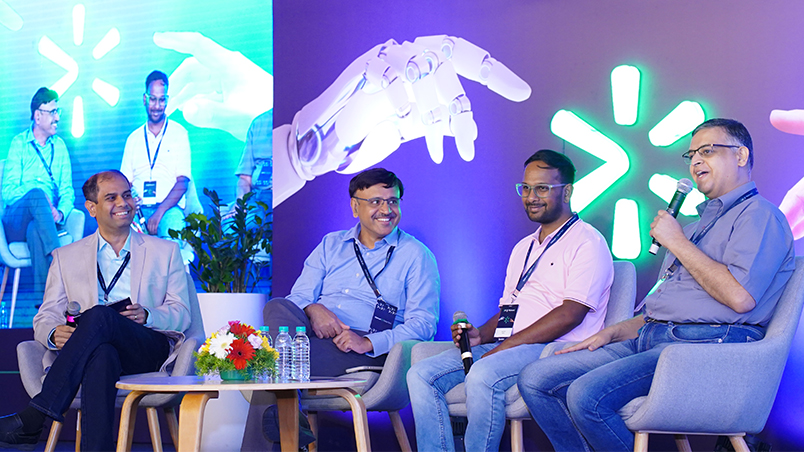 A panel discussion on stage, featuring renowned technology leaders across industries.