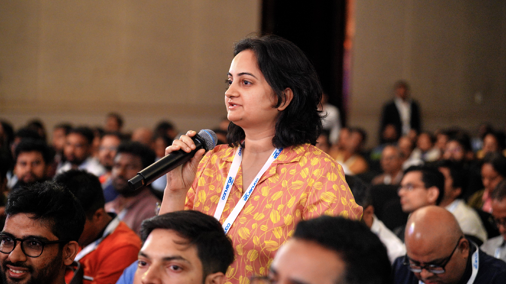 Audience member asking question to the panelist