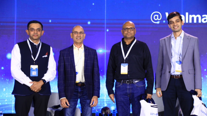 Tathagat Verma, Sr. Director, TechOps, Walmart Global Tech; Raghu Krishnananda, CPTO, Myntra; Subram Natarajan, Director, Customer Engineering, Google and Amith Singhee, Director, IBM Research, stand together on stage at Converge @ Walmart after a panel discussion.