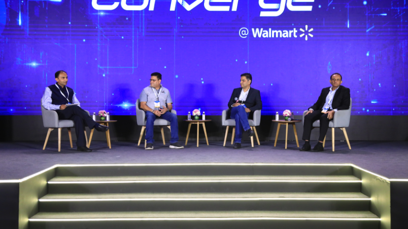 Panel discussion taking place on stage at Converge @ Walmart, featuring Rajiv Bhuta, VP, Product, Walmart Global Tech; Hemant Badri, SVP, Supply Chain, Customer Experience and ReCommerce, Flipkart; Kapil Mahajan, Global CIO, Allcargo Logistics and Abhishek Nehru, Co-founder, Ripplr.