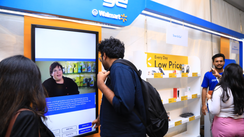 : A participant at Converge @ Walmart watches a digital display of Walmart’s innovations at the event’s Experience Zone.